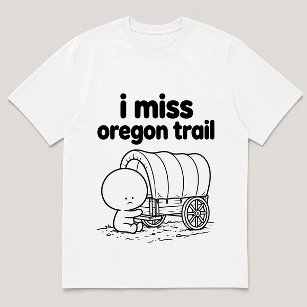 lonely boi tee: a small sad cartoon boy hugging a covered wagon on a dusty trail, with the words i miss oregon trail above him