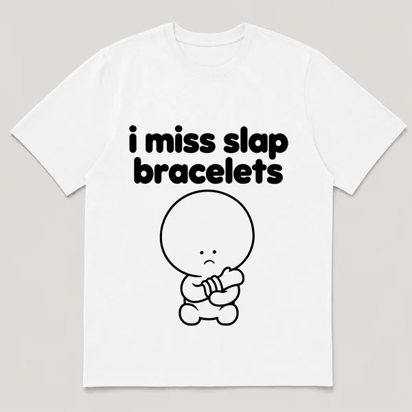 lonely boi tee: a small sad cartoon boy hugging a curled slap bracelet around a wrist, with the words i miss slap bracelets above him